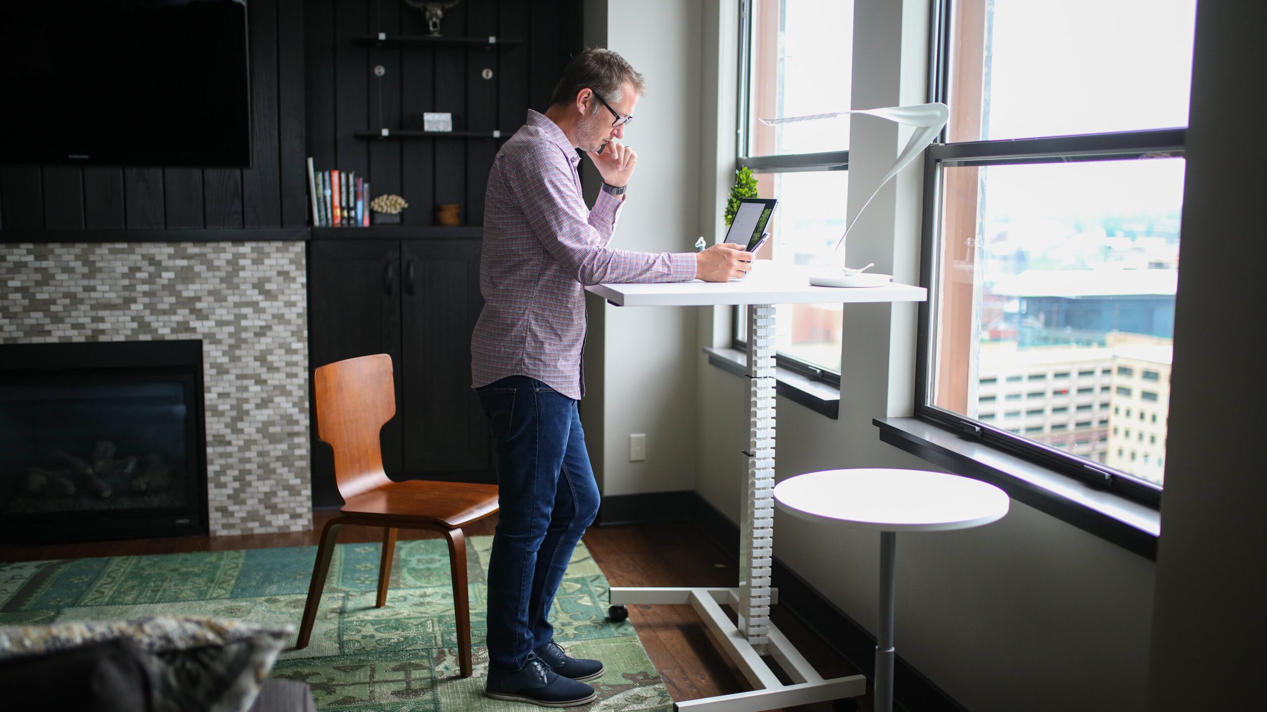 Man proactively incorporating movement medicine with a stand up desk 